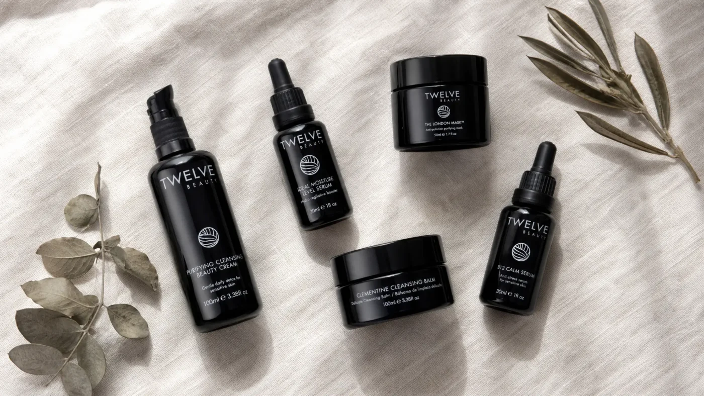 Twelve Beauty skincare products flat lay featuring black glass bottles and jars for sensitive skin barrier repair